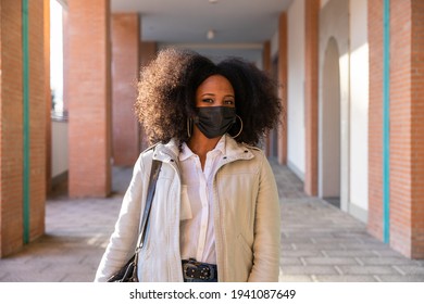 Young Commuter Woman In City In Sustainable Way Wearing Protective Face Mask Against Coronavirus Covid-19 Pandemic Walking On Way Home To Work - Safety And Commuting Concept