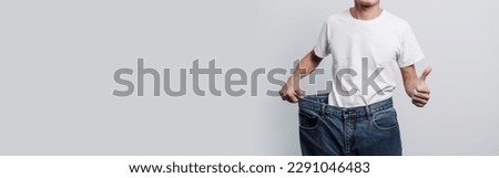 Young confident asian chinese weight loss man with oversize of jean pants. Сток-фото © 