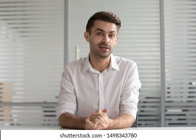 Young Confident Businessman Looking At Camera, Talking To Client. Concentrated Male Hr Manager Holding Video Distant Job Interview. Professional Tutor Recording Educational Vlog Lecture, Webcam View.