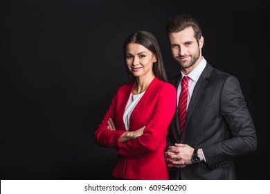 Young confident businesspeople  in formalwear smiling at camera isolated on black - Shutterstock ID 609540290