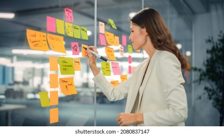 Young Confident Businesswoman Creating Project Plan on Office Wall with Paper Notes. Stylish Beautiful Manager Working on Business, Financial and Marketing Projects. Specialist in Diverse Team. - Shutterstock ID 2080837147