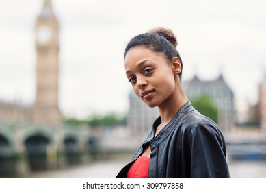 Young confident businesswoman portrait outdoors in London with Big Ben as background.