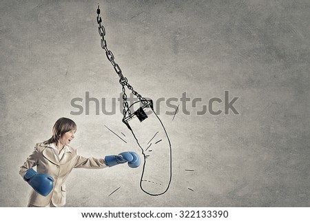 Young confident businesswoman wearing blue boxing gloves