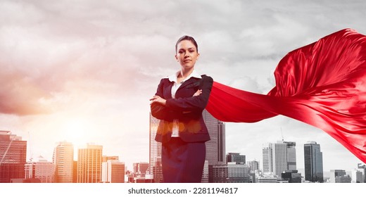 Young confident businesswoman wearing red cape against modern city background - Powered by Shutterstock