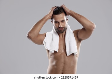 Young Confident Caucasian Man With Towel Touching His Hair. Handsome Bearded Guy With Naked Torso Looking At Camera. Concept Of Male Beauty. Isolated On White Background. Studio Shoot. Copy Space