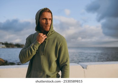 Young confident cool strong sporty athletic toned fit sportsman man wear grey sports casual clothes warm up training at sunrise sun dawn over sea beach outdoor on pier seaside in summer day morning - Powered by Shutterstock