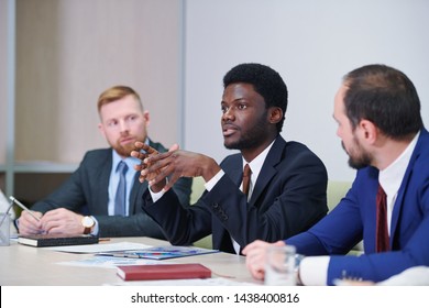 Young confident delegate or trader explaining idea