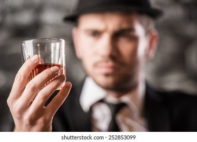 Young, Confident, Gangster Man Is Drinking A Whisky.