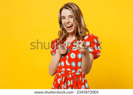 Young confident leader caucasian woman she wear red dress casual clothes point index finger camera on you motivating encourage isolated on plain yellow background studio portrait. Lifestyle concept