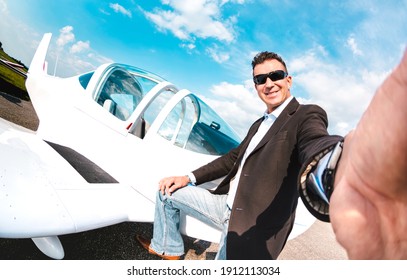 Young Confident Man Taking Selfie With Mobile Smart Phone At Private Airplane - Modern Business Concept With Rich Guy Ready For Luxury Excursion