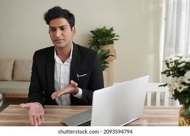 Young Confident Property Insurance Agent Talking To Customer At His Office