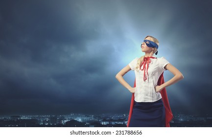 Young Confident Woman In Red Cape And Mask