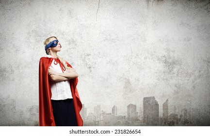 Young Confident Woman In Red Cape And Mask