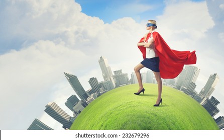 Young Confident Woman In Red Cape And Mask