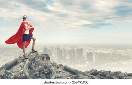 Young Confident Woman In Red Cape And Mask