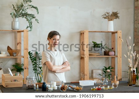 Similar – Woman in work wear in her workshop by table with handmade items