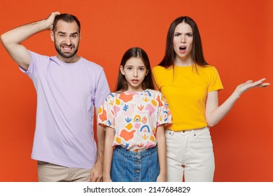 Young Confused Sad Happy Parents Mom Dad With Child Kid Daughter Teen Girl In Basic T-shirts Scratch Head Spread Hands Isolated On Yellow Background Studio. Family Day Parenthood Childhood Concept.