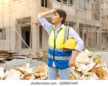 Young Construction Engineer Woman Holds Safety Helmet Is Exhausted Due To Working In The Sun. Beautiful Architect Feel Stress Of Doing Jobs Outdoors In Heat. Construction Worker Overworked And Sweat.