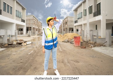 Young Construction Engineer Woman Wears Safety Helmet Tired Exhausted Due To Working In The Sun. Beautiful Architect Feel Stress Of Doing Job Outdoor In Heat. Construction Worker Overworked And Sweat.