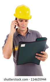 Young Construction Worker Speaking On Cellphone While Reading A Document