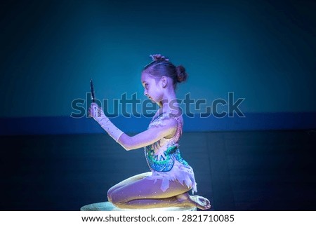 Young contortionist posing with a mirror on a stage table. Concept: Artistic circus performance, stage storytelling, and youth entertainment