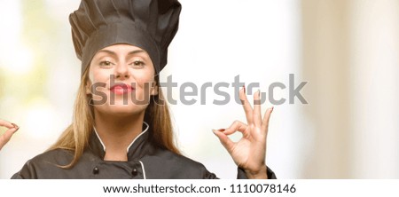Young cook woman doing ok sign gesture with both hands expressing meditation and relaxation