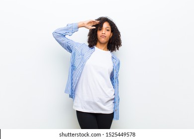 Young Cool African American Woman Greeting The Camera With A Military Salute In An Act Of Honor And Patriotism, Showing Respect