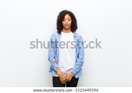 young cool african american woman looking goofy and funny with a silly cross-eyed expression, joking and fooling around