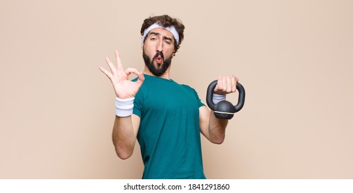 Young Cool Bearded Man At Gym With A Dumbbell. Sport Concept