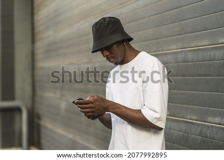 Similar – Attractive black man listening to music with earphones