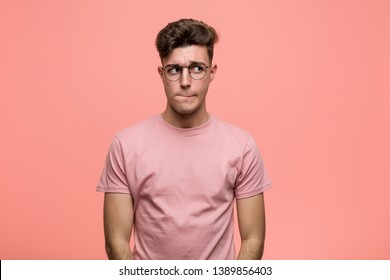 Young cool caucasian man confused, feels doubtful and unsure. - Shutterstock ID 1389856403