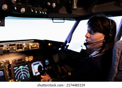 Young Copilot Using Power Switch On Dashboard To Fly Aircraft Jet, Pushing Control Panel Lever And Navigation Command In Cockpit Cabin. Flying Airplane With Dashboard Buttons And Handle.