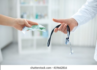 Young Corrupt Doctor Taking Bribe From Patient