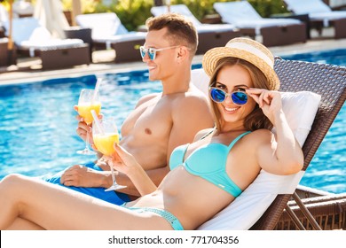 Young couple active leisure swimming pool concept - Powered by Shutterstock