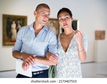 Young Couple Admiring Art Work In Museum