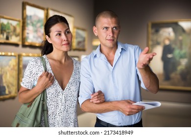 Young Couple Admiring Art Work In Museum