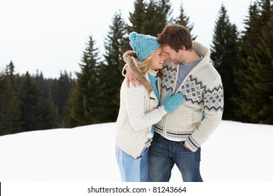 Young Couple In Alpine Snow Scene