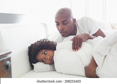 Young couple arguing in bed at home in the bedroom