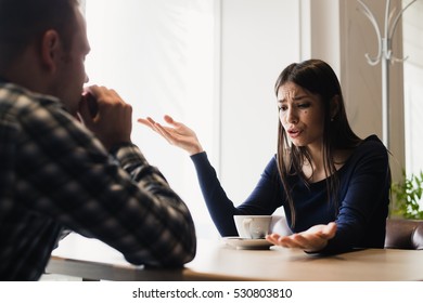 Young couple arguing in a cafe. Relationship problems. - Powered by Shutterstock