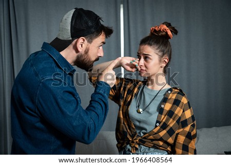 Young couple arguing a man with his hand pint a finger in her face threaten a woman, domestic violence and abuse concept