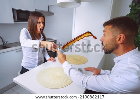 Young couple arguing. Relationship problems. Angry woman throws coffee in mans face.