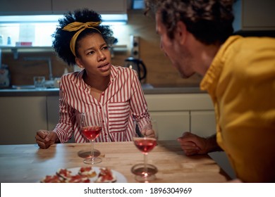 A Young Couple Arguing While Eating In A Tense Atmosphere At The Kitchen. Dinner, Relationship, Together, Home