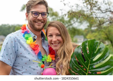 Young Couple At A Backyard Tropical Theme Party