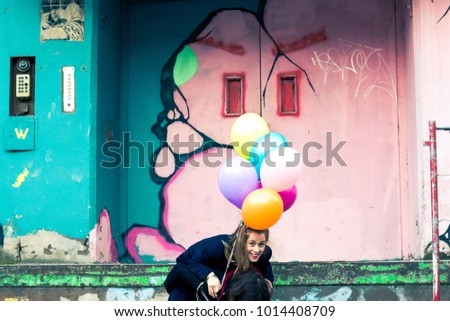 Young teenage girl blowing pink bubble gum