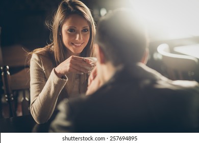 Young Couple At The Bar Having A Coffee And Flirting