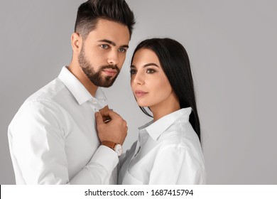 Young Couple With Beautiful Healthy Hair On Grey Background