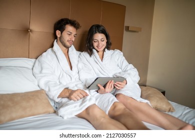 Young Couple In Bed Sharing A Digital Tablet