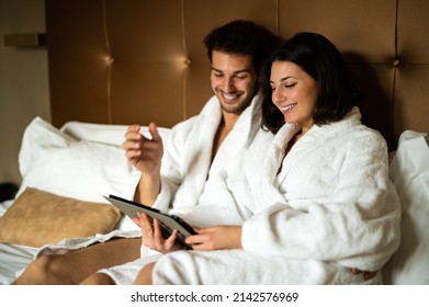 Young Couple In Bed Sharing A Digital Tablet