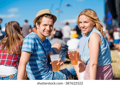 Young Couple With Beer At Summer Music Festival