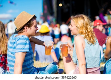 Young Couple With Beer At Summer Music Festival